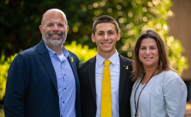 Group of three smiling parents at a community event