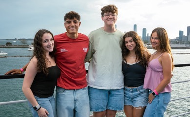 Group of three smiling parents at a community event