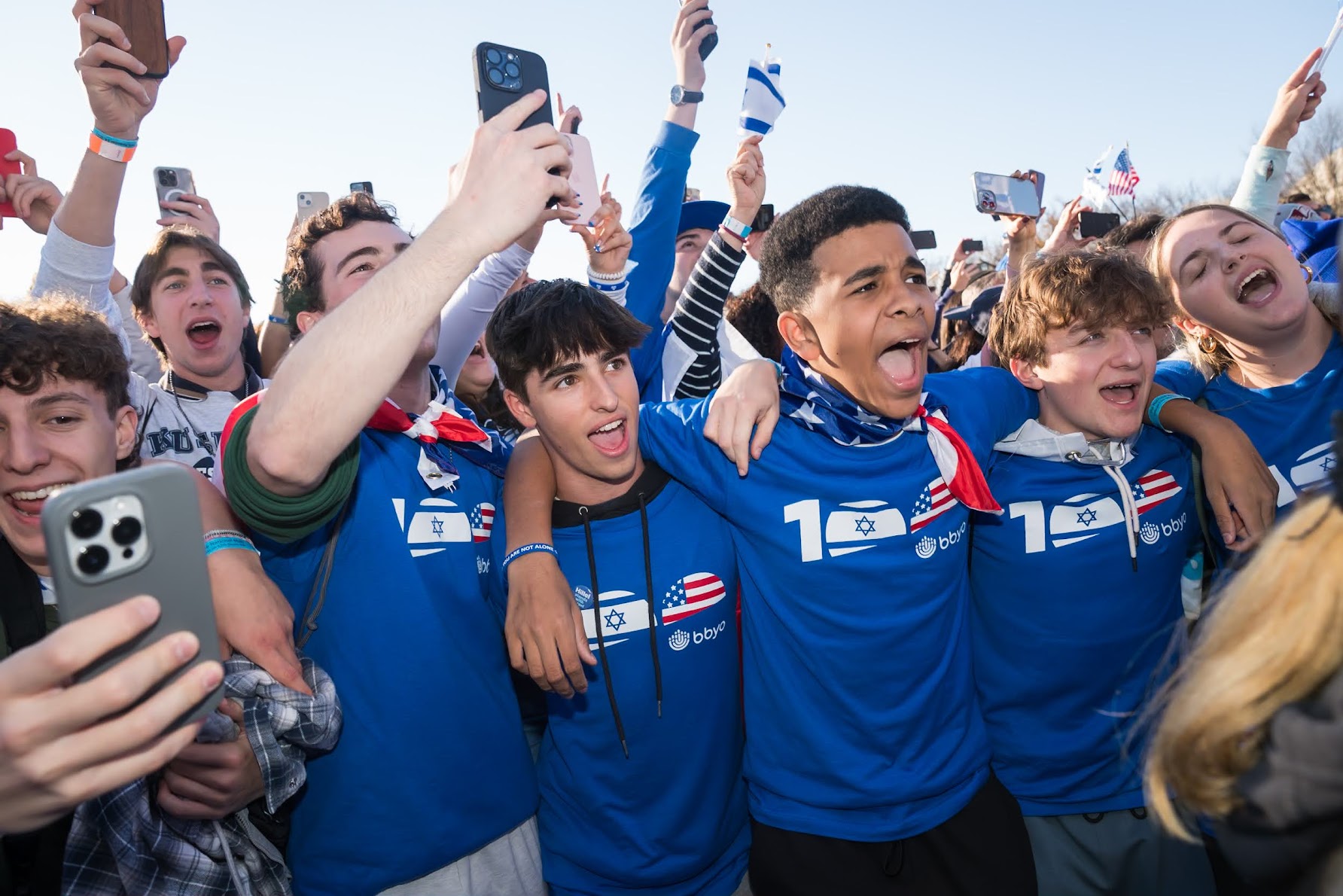 Group of diverse young people smiling at a community event