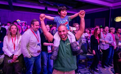 Group of three smiling parents at a community event