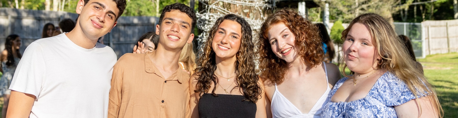 Group of diverse young people smiling at a community event