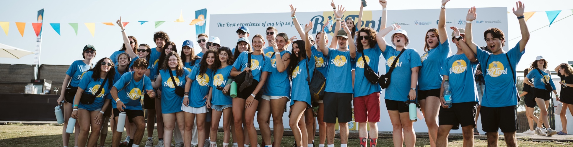 Group of diverse young people smiling at a community event