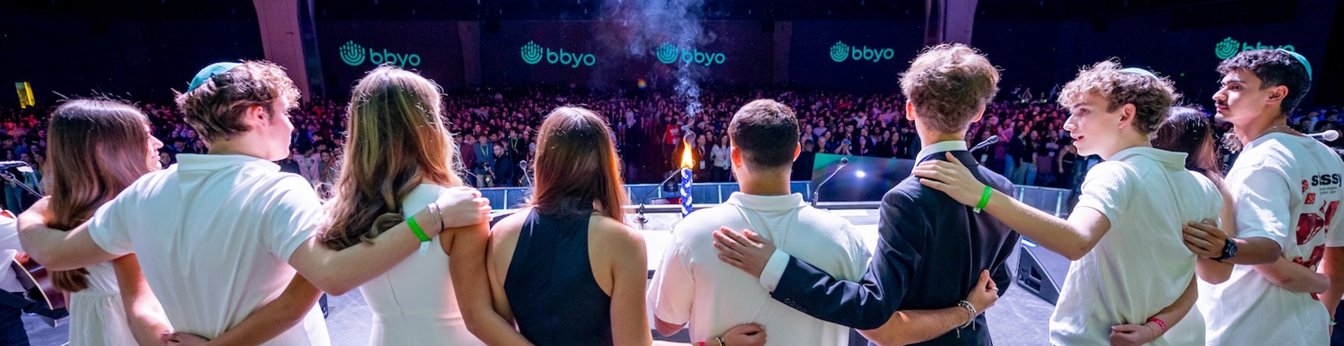 Group of diverse young people smiling at a community event
