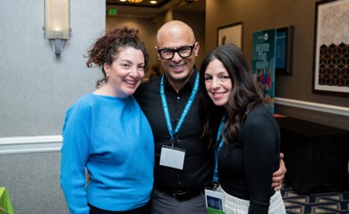 Group of three smiling parents at a community event