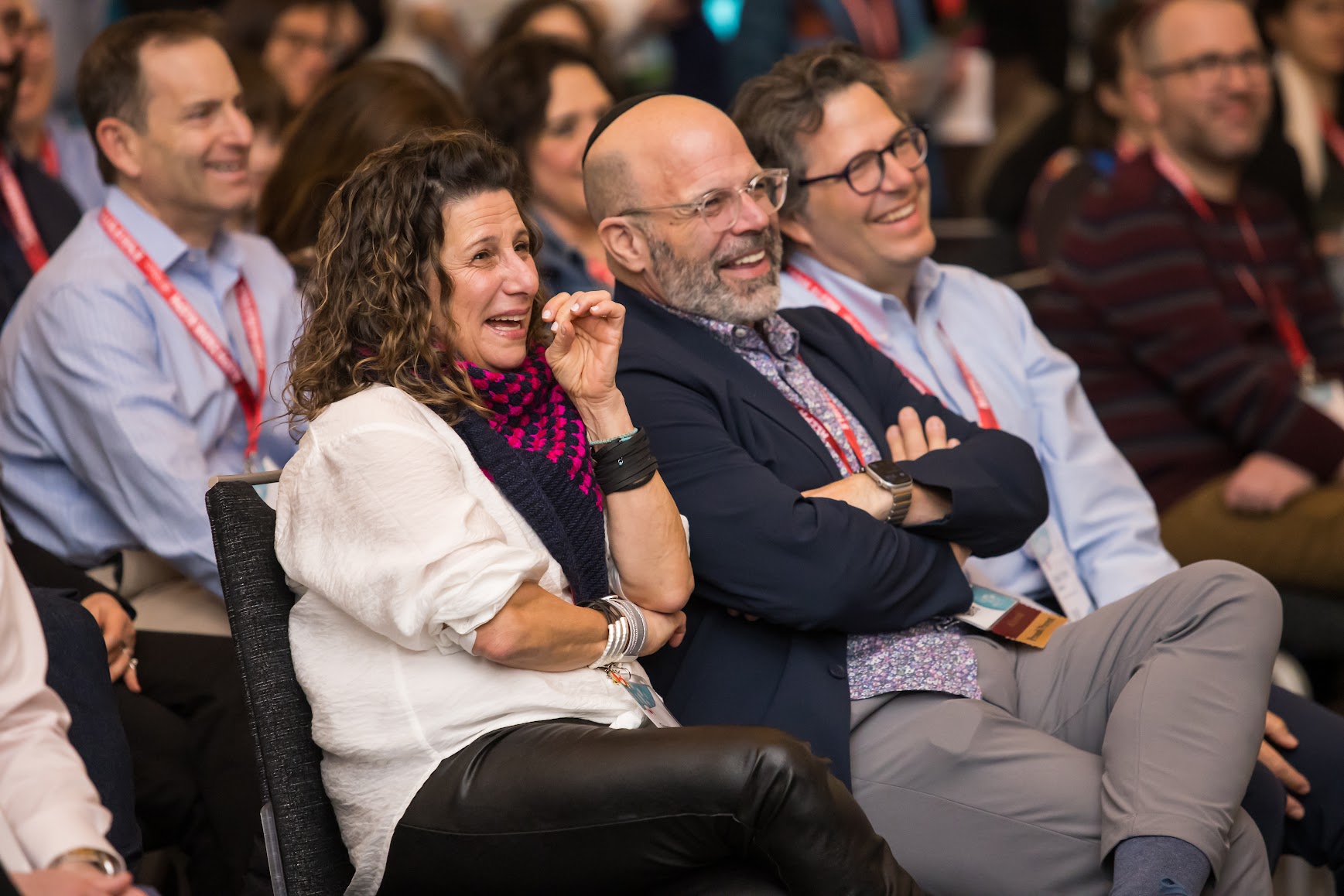 Group of three smiling parents at a community event
