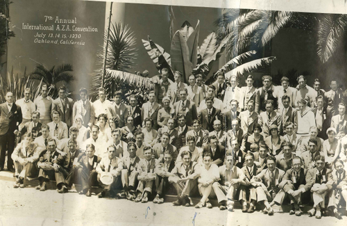 A diverse crowd of people celebrating at a concert, raising their hands and cheering.