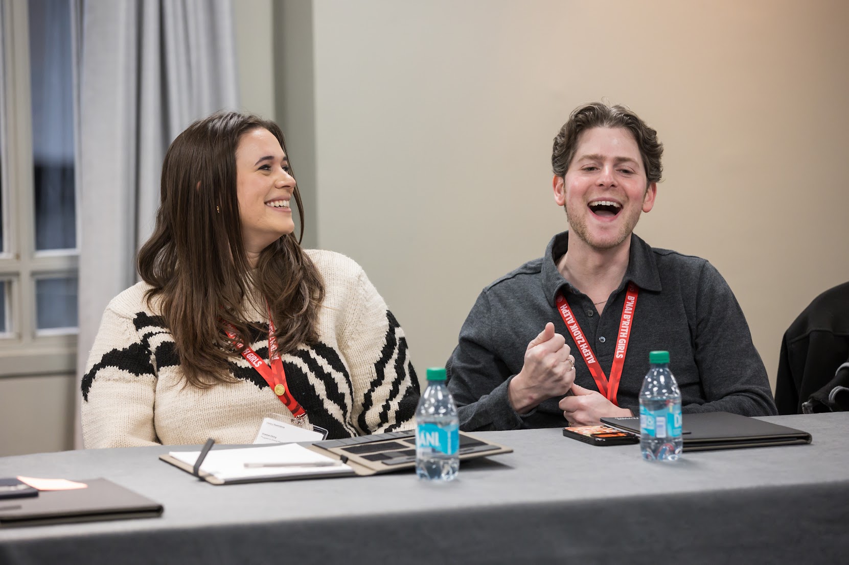 Group of three smiling parents at a community event