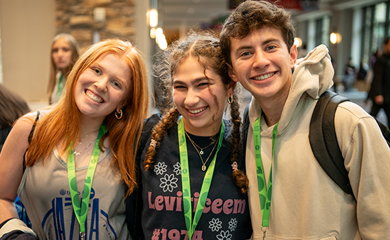 Group of three smiling parents at a community event