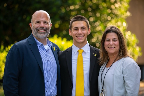 Group of three smiling parents at a community event