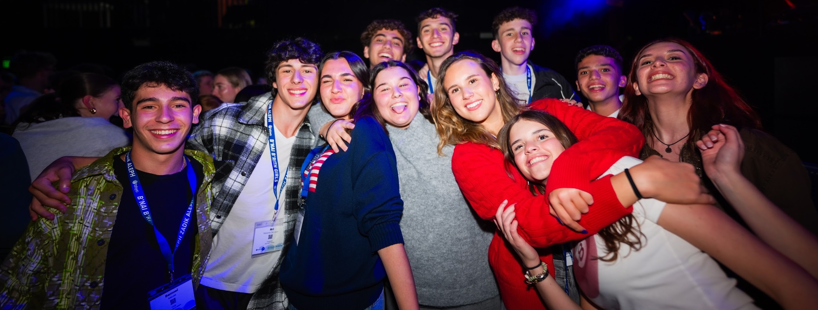 Group of diverse young people smiling at a community event