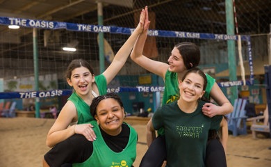 Group of three smiling parents at a community event
