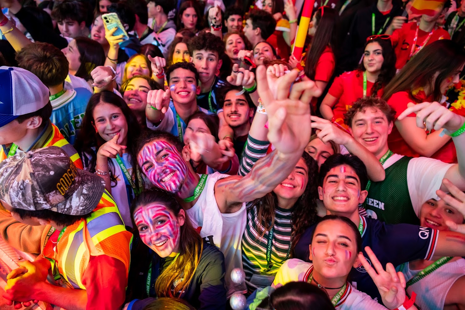 BBYO Centennial celebration with confetti, lights, and a crowd of attendees