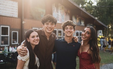 Group of three smiling parents at a community event